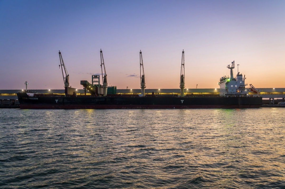 Geared vessel loading project cargo at berth